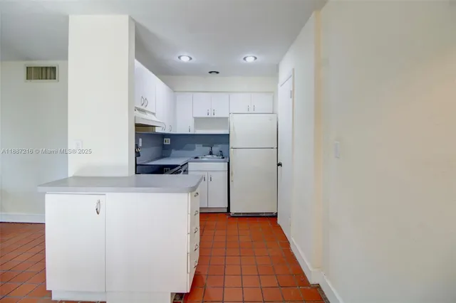 a view of an empty room with glass door