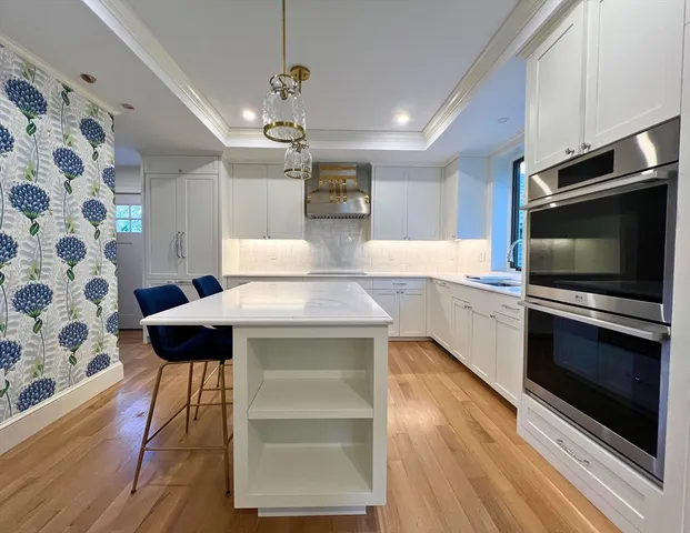 a kitchen with a sink stainless steel appliances and cabinets