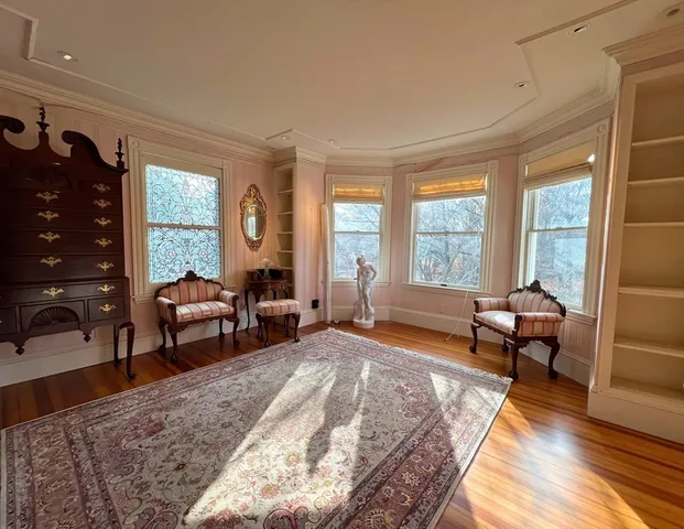 a bedroom with furniture and a large window