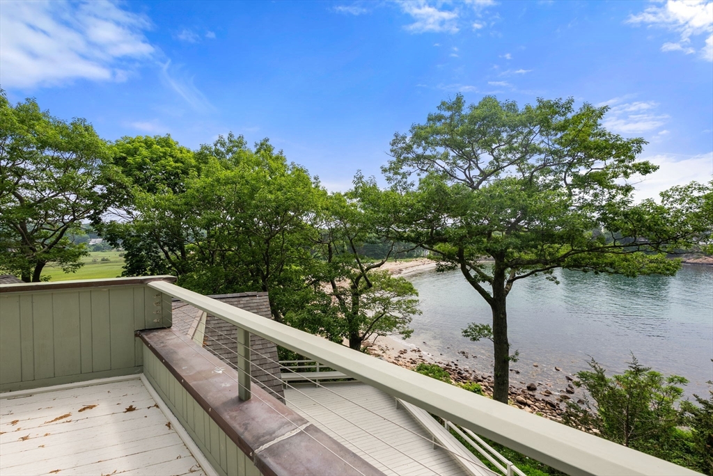 23 Ocean Street Manchester, MA 01944 - Photo 23 of 36 a view of balcony with lake and trees in the background