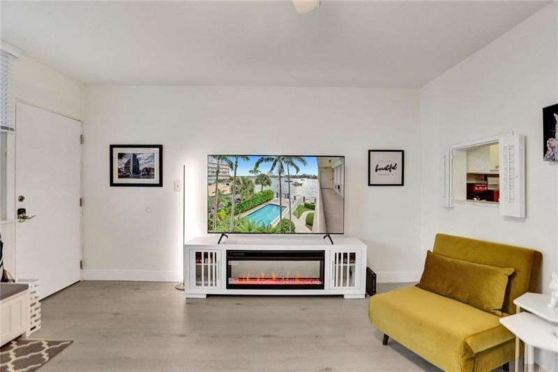 101 North Birch Road, Unit 303 Fort Lauderdale, FL 33304 - Photo 11 of 29 a living room with furniture a window and a flat screen tv
