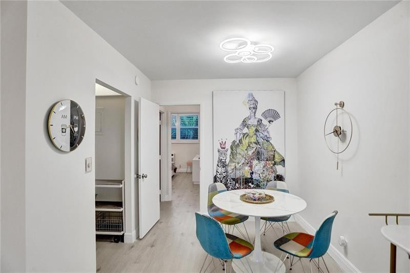 101 North Birch Road, Unit 303 Fort Lauderdale, FL 33304 - Photo 13 of 29 a view of a dining room with furniture and a chandelier