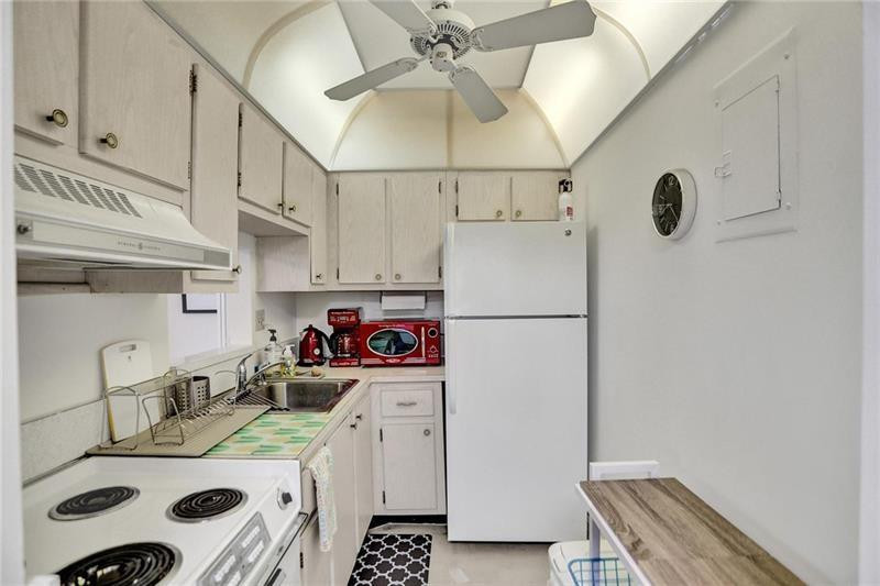 101 North Birch Road, Unit 303 Fort Lauderdale, FL 33304 - Photo 14 of 29 a kitchen with stainless steel appliances a sink a stove a refrigerator and cabinets