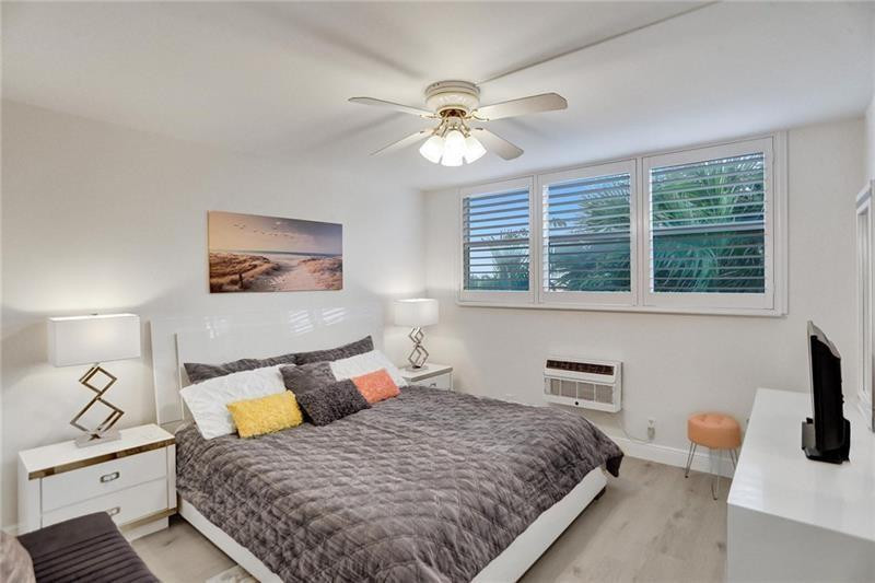 101 North Birch Road, Unit 303 Fort Lauderdale, FL 33304 - Photo 15 of 29 a bedroom with a large bed and a window