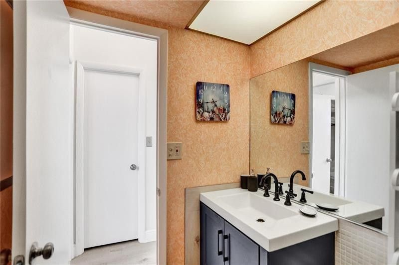 101 North Birch Road, Unit 303 Fort Lauderdale, FL 33304 - Photo 19 of 29 a bathroom with a sink and a mirror
