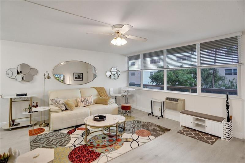 101 North Birch Road, Unit 303 Fort Lauderdale, FL 33304 - Photo 5 of 29 a living room with furniture and a large window