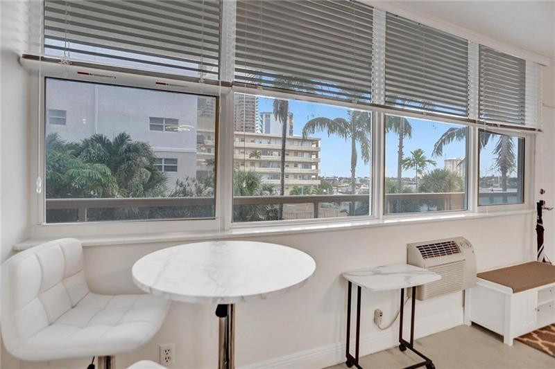 101 North Birch Road, Unit 303 Fort Lauderdale, FL 33304 - Photo 8 of 29 a view of a dining room with furniture and window