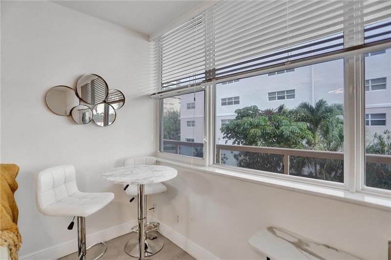 101 North Birch Road, Unit 303 Fort Lauderdale, FL 33304 - Photo 9 of 29 a view of a dining room with furniture window and outside view