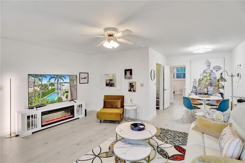 101 North Birch Road, Unit 303 Fort Lauderdale, FL 33304 - Photo 10 of 29 a living room with furniture and a flat screen tv