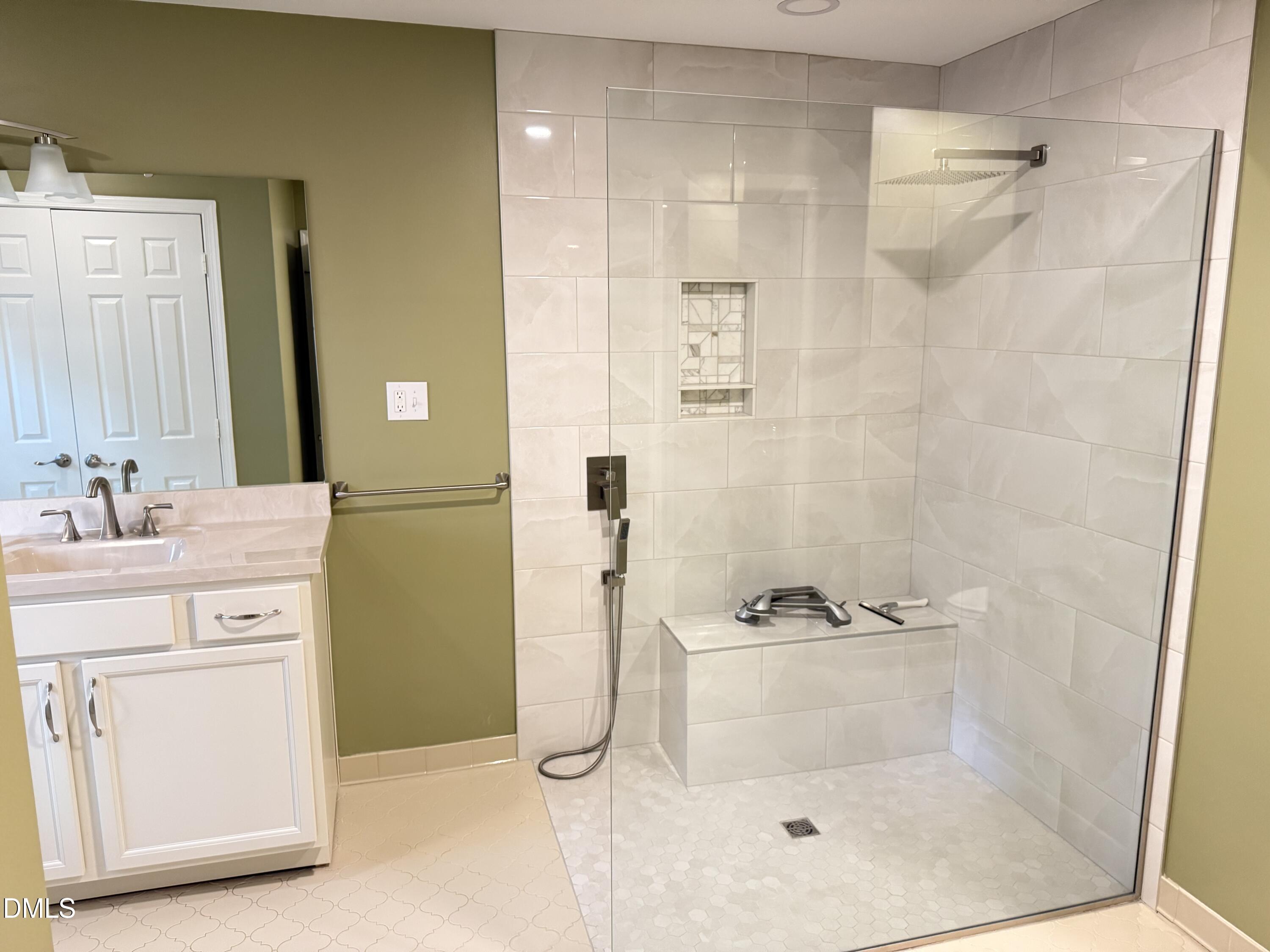 120 Keeter Circle Wake Forest, NC 27587 - Photo 12 of 36 a bathroom with a shower sink and mirror