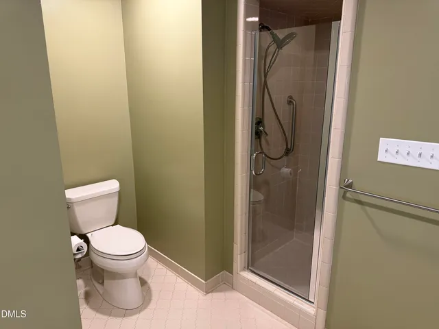a bathroom with a toilet and shower