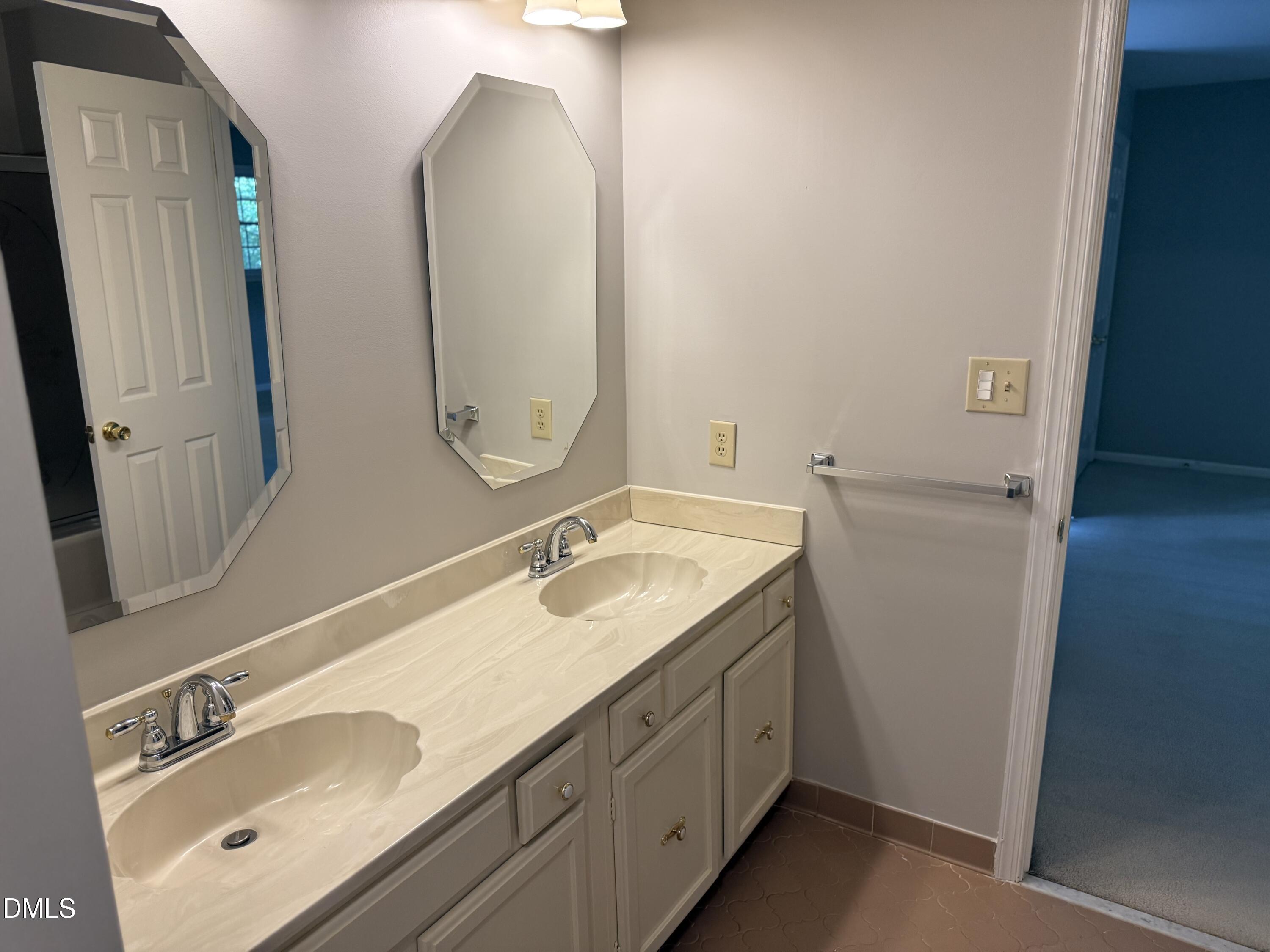 120 Keeter Circle Wake Forest, NC 27587 - Photo 19 of 36 a bathroom with a double vanity sink and mirror