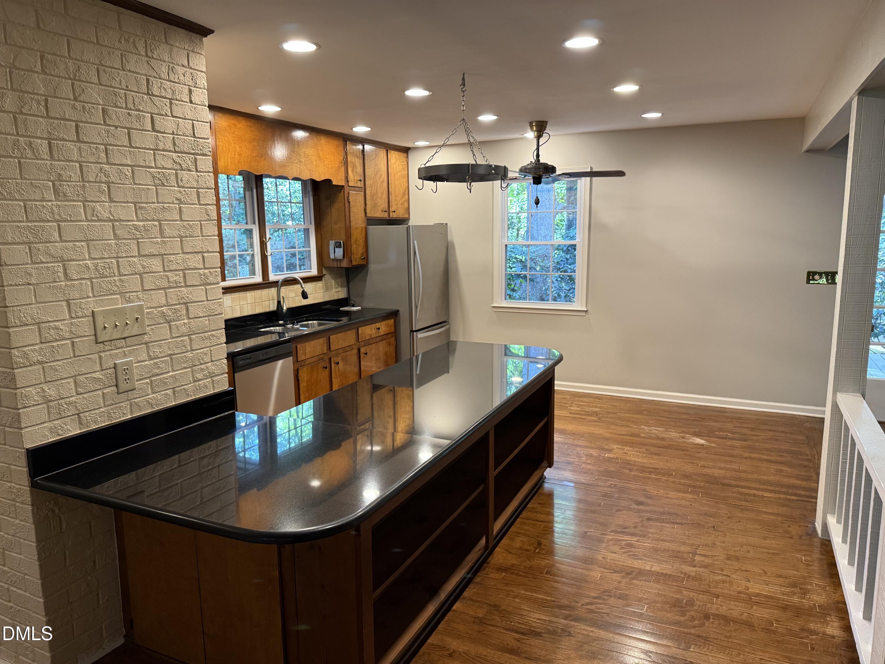 120 Keeter Circle Wake Forest, NC 27587 - Photo 2 of 36 a kitchen with stainless steel appliances a dining table chairs and wooden floor