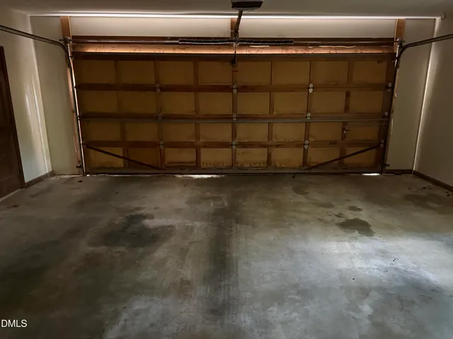 a red car parked in front of a house