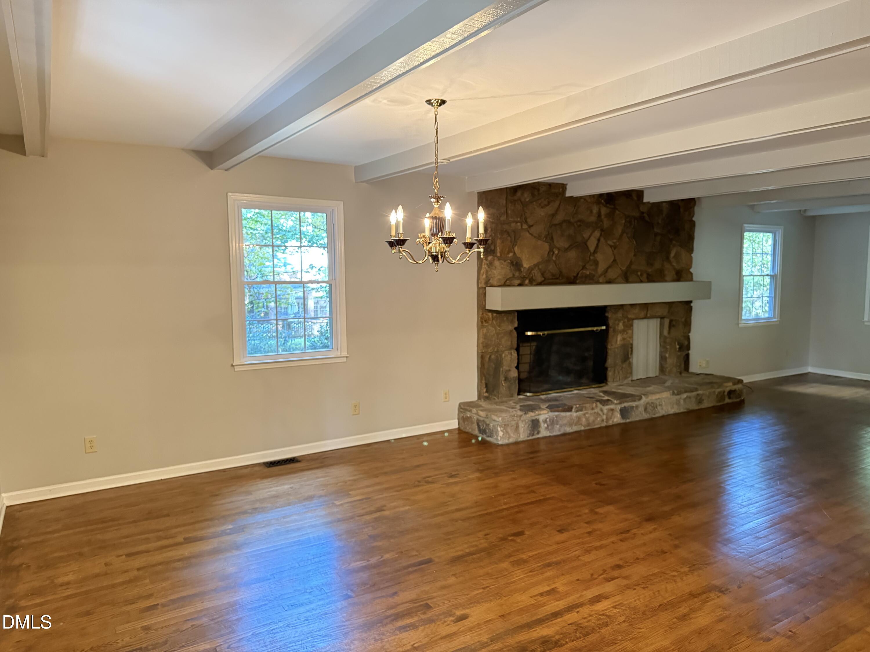 120 Keeter Circle Wake Forest, NC 27587 - Photo 5 of 36 a view of a livingroom with a fireplace wooden floor and windows
