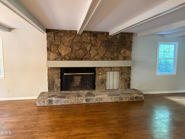 a living room with fireplace furniture and a fireplace