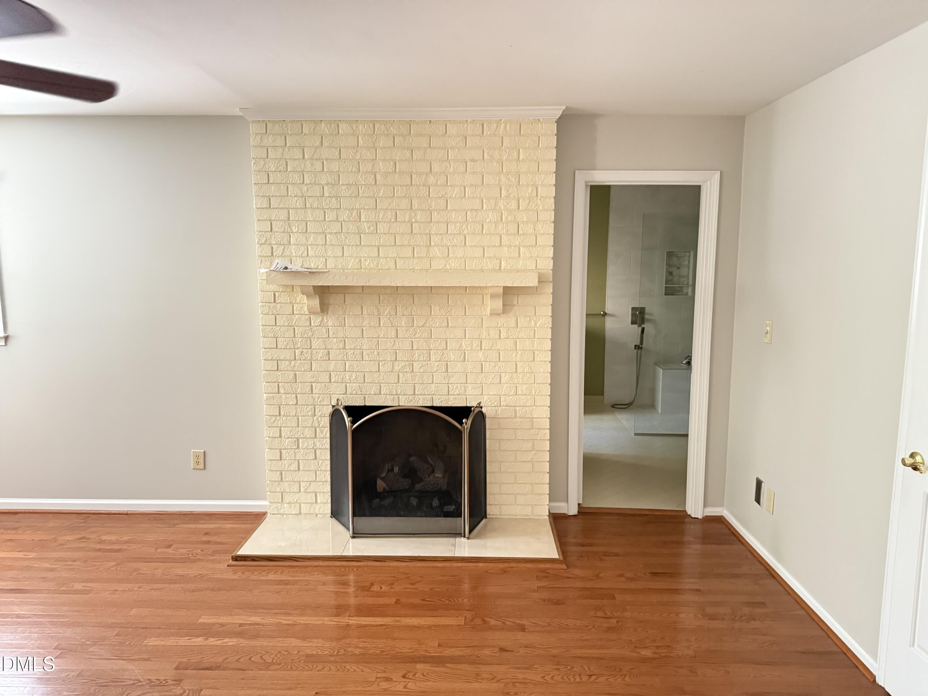 120 Keeter Circle Wake Forest, NC 27587 - Photo 10 of 36 a view of an empty room with wooden floor and a fireplace