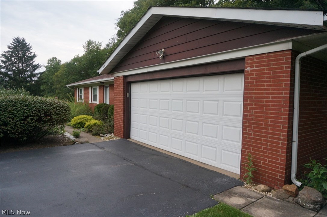 1087 Broadmoor Road Macedonia, OH 44056 - Photo 30 of 35 The insulated garage door and the recently (2016) seal-coated, long asphalt driveway.