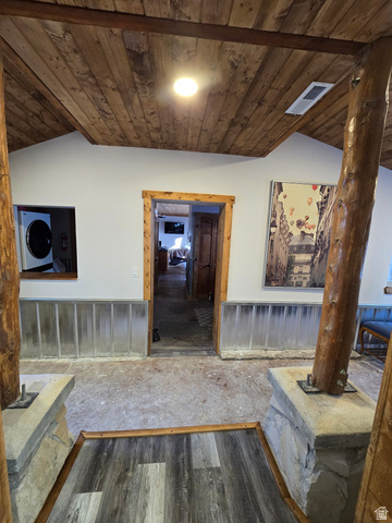 2029 West Tollgate Road Coalville, UT 84017 - Photo 30 of 36 Wood-finish plank ceiling with exposed beams, stone base columns, and wood-trimmed doorways