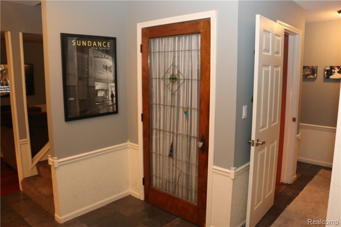9404 Mabley Hill Road Fenton, MI 48430 - Photo 13 of 46 Slate foyer with antique stained-glass closet door.