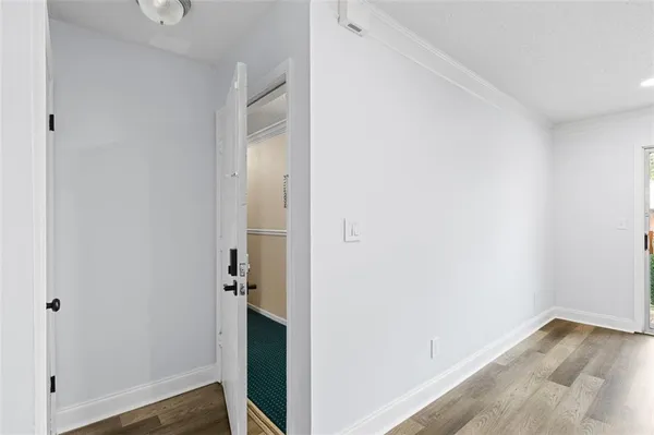 a view of a hallway with wooden floor