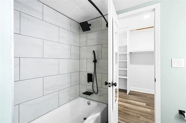a bathroom with a tub and shower