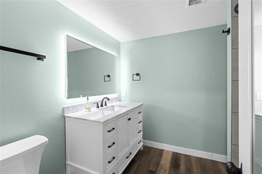 6851 Roswell Road, Unit N10 Atlanta, GA 30328 - Photo 13 of 26 a bathroom with a sink and a mirror