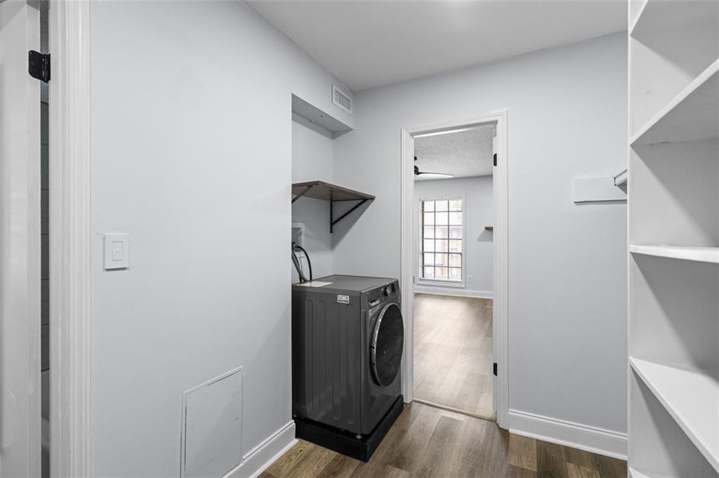 6851 Roswell Road, Unit N10 Atlanta, GA 30328 - Photo 16 of 26 a view of a storage and utility room with closet and wooden floor