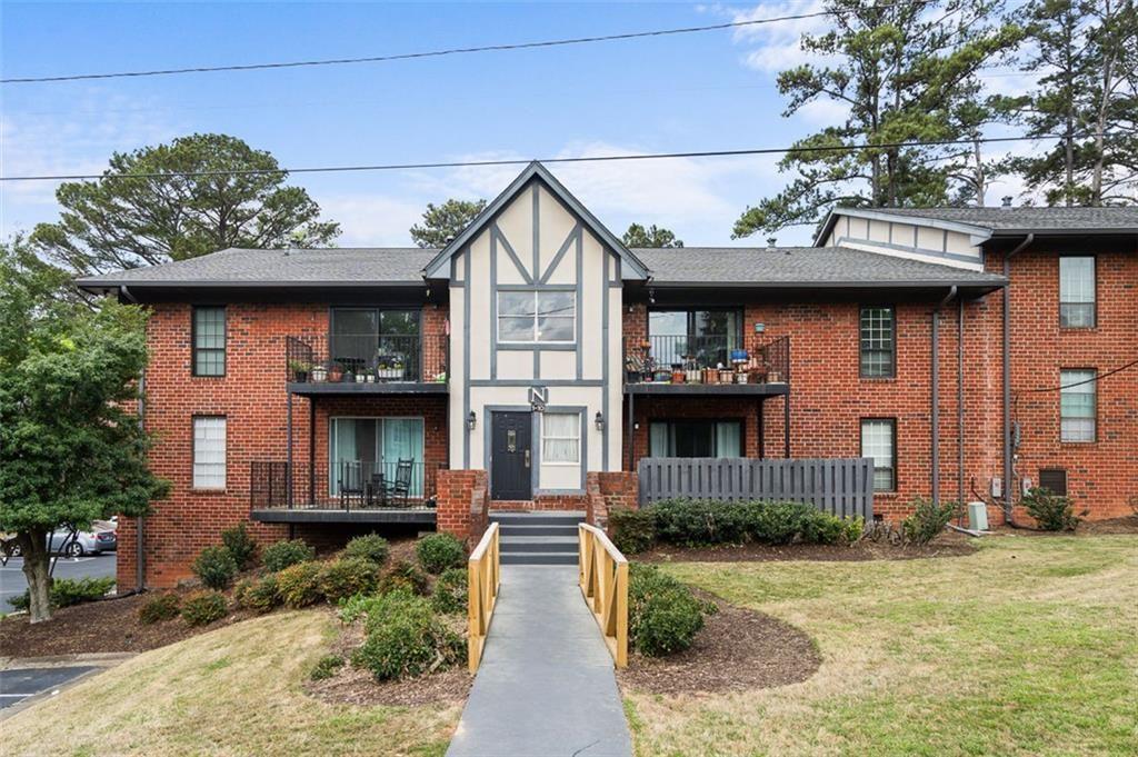 6851 Roswell Road, Unit N10 Atlanta, GA 30328 - Photo 24 of 26 a front view of a house with a garden