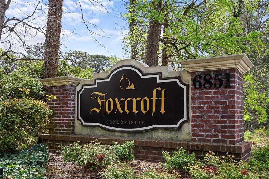 6851 Roswell Road, Unit N10 Atlanta, GA 30328 - Photo 25 of 26 a sign that is sitting on a brick wall