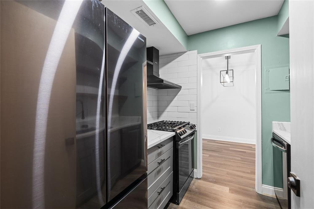 6851 Roswell Road, Unit N10 Atlanta, GA 30328 - Photo 3 of 26 a kitchen with stainless steel appliances granite countertop a refrigerator and a stove