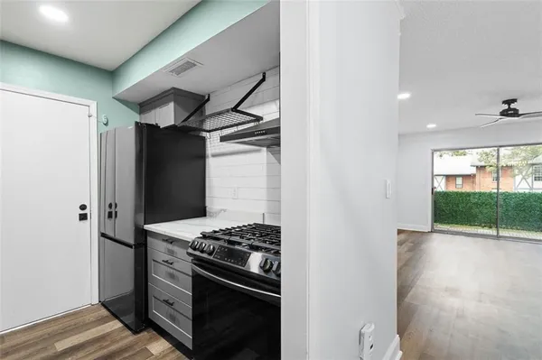 a kitchen with stainless steel appliances a stove and a refrigerator