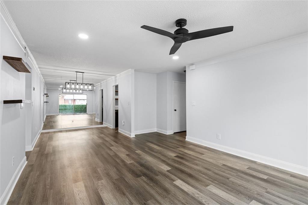 6851 Roswell Road, Unit N10 Atlanta, GA 30328 - Photo 6 of 26 a view of a livingroom with wooden floor and a ceiling fan