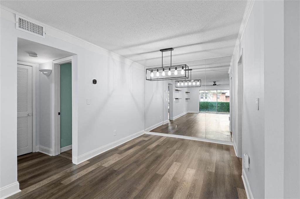 6851 Roswell Road, Unit N10 Atlanta, GA 30328 - Photo 10 of 26 a view of empty room with wooden floor