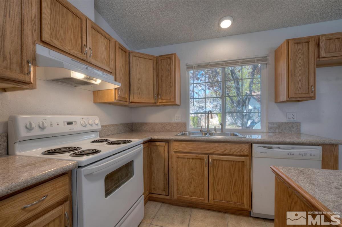 1645 Wyoming Avenue Reno, NV 89503 - Photo 12 of 28 a kitchen with granite countertop a sink stove and cabinets