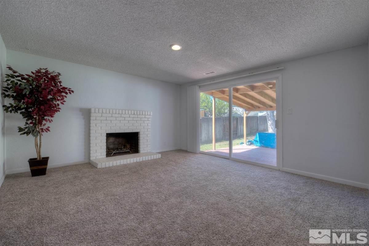 1645 Wyoming Avenue Reno, NV 89503 - Photo 15 of 28 a view of an empty room with a window and a fireplace