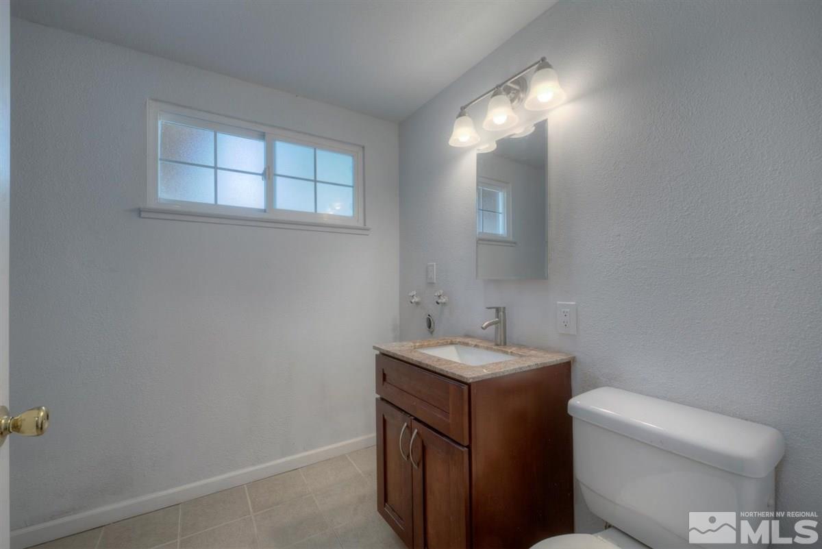 1645 Wyoming Avenue Reno, NV 89503 - Photo 24 of 28 a bathroom with a toilet sink and mirror