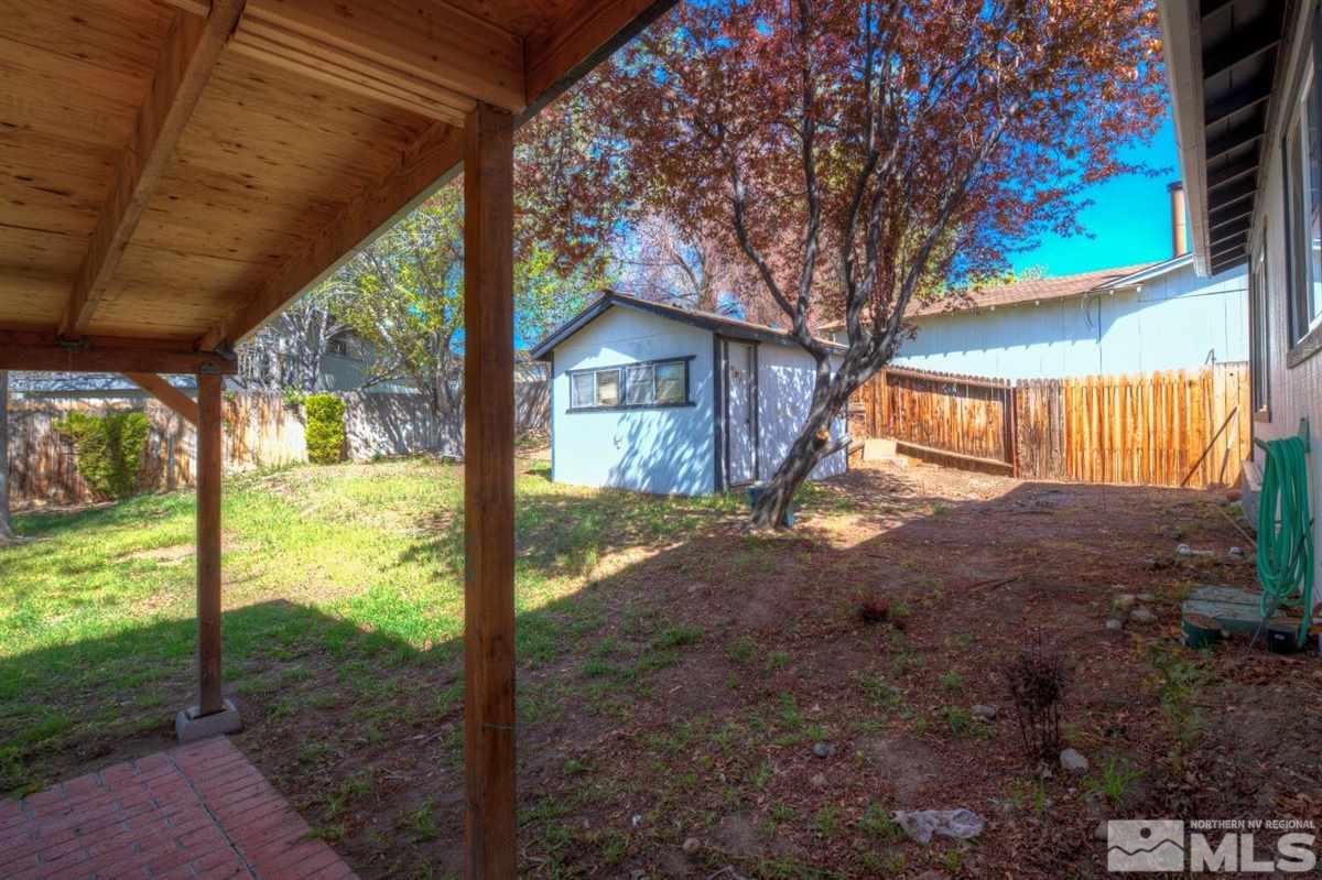 1645 Wyoming Avenue Reno, NV 89503 - Photo 5 of 28 a view of a house with backyard and a tree