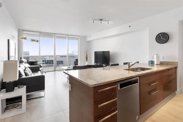 a kitchen with a sink a stove and chairs