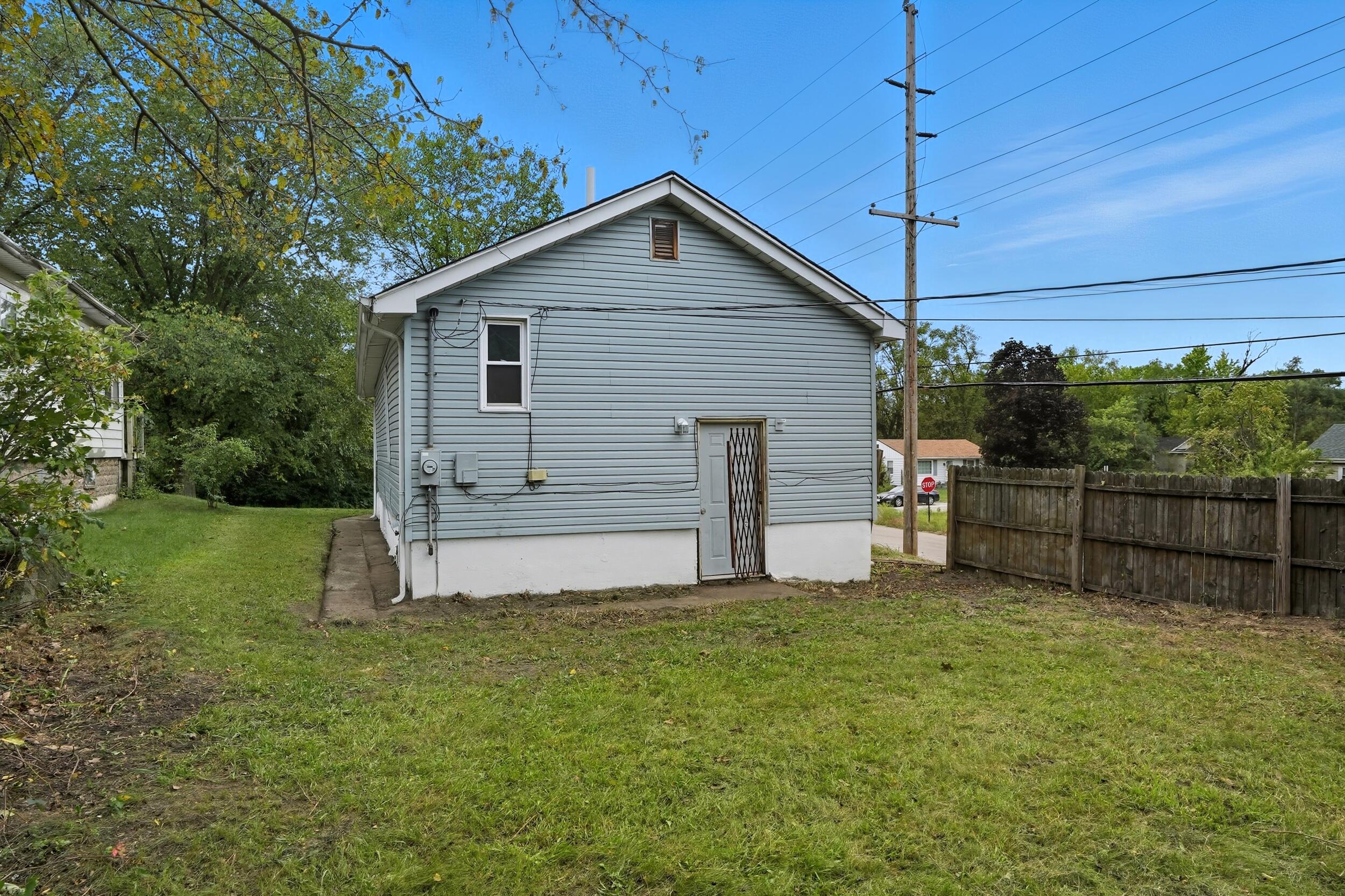 4001 Virginia Street Gary, IN 46409 - Photo 2 of 12 a view of a backyard with plants and large tree