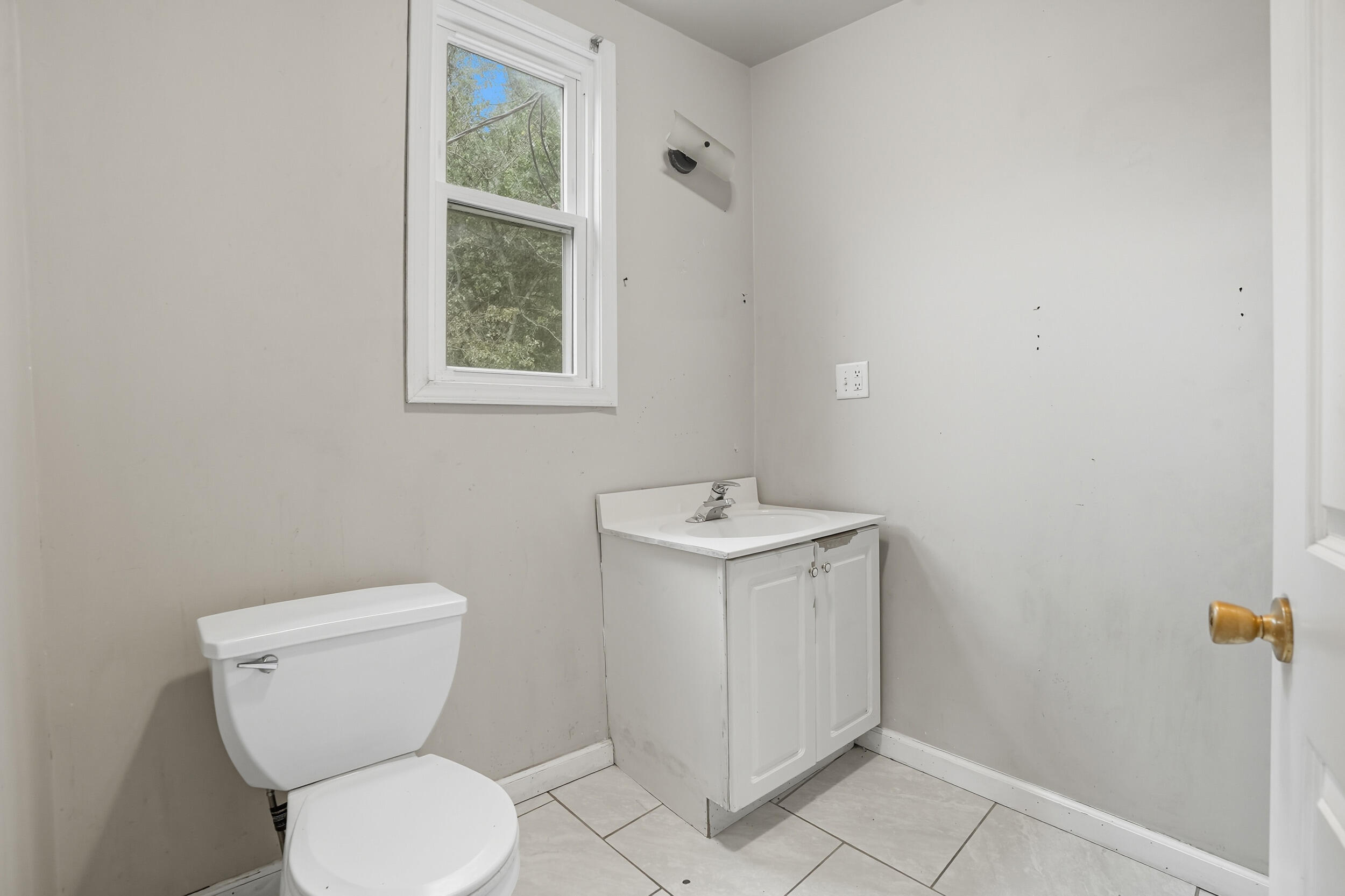 4001 Virginia Street Gary, IN 46409 - Photo 10 of 12 a bathroom with a toilet sink and mirror
