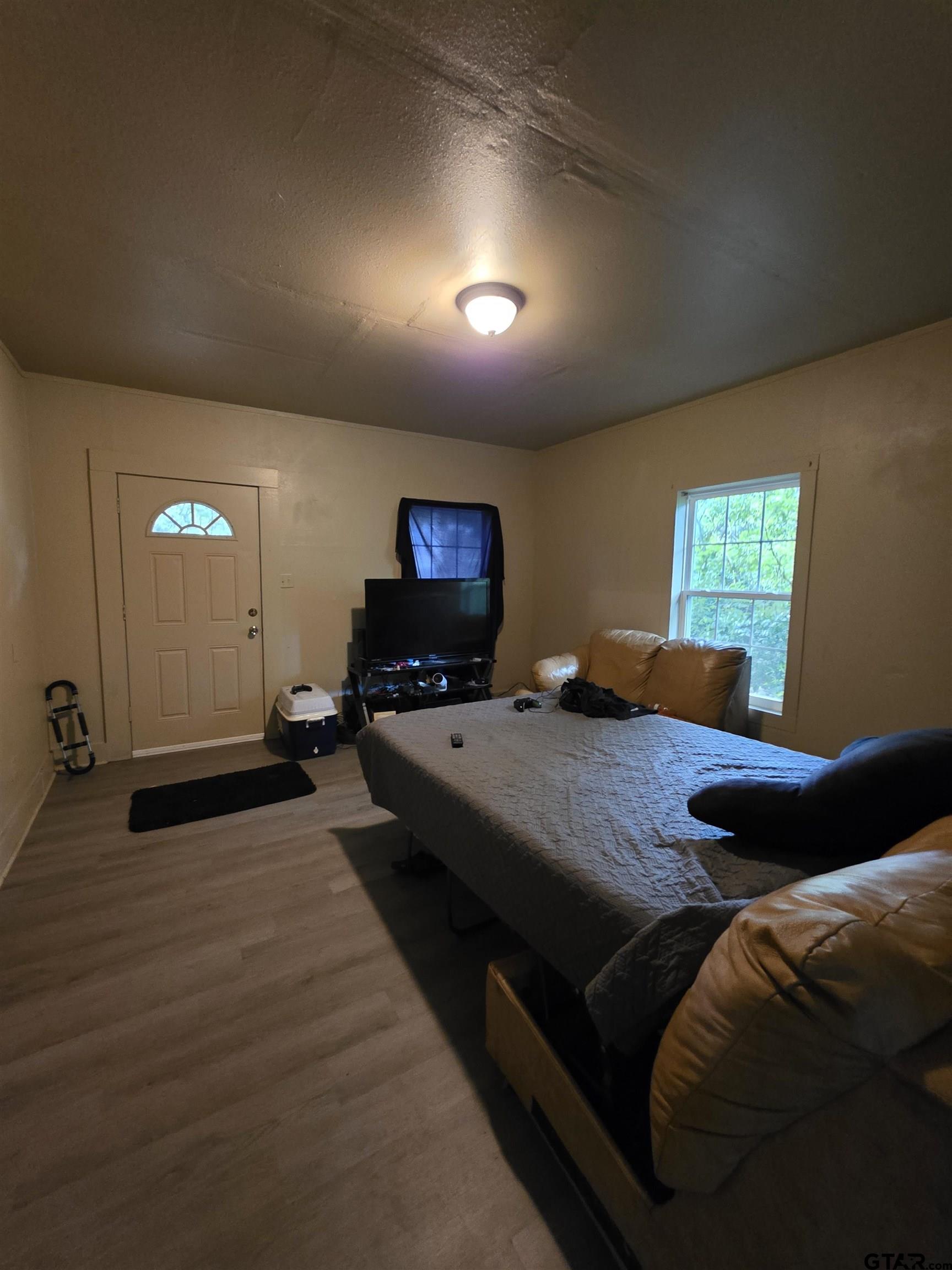 316 North Hospital Street Rusk, TX 75785 - Photo 8 of 21 a bedroom with a bed and wooden floor