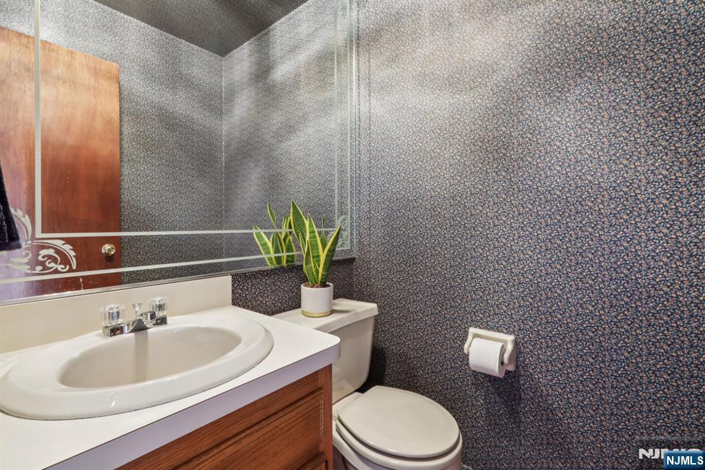 70 River Road, Unit C003 Clifton, NJ 07014 - Photo 17 of 35 a bathroom with a sink toilet and mirror