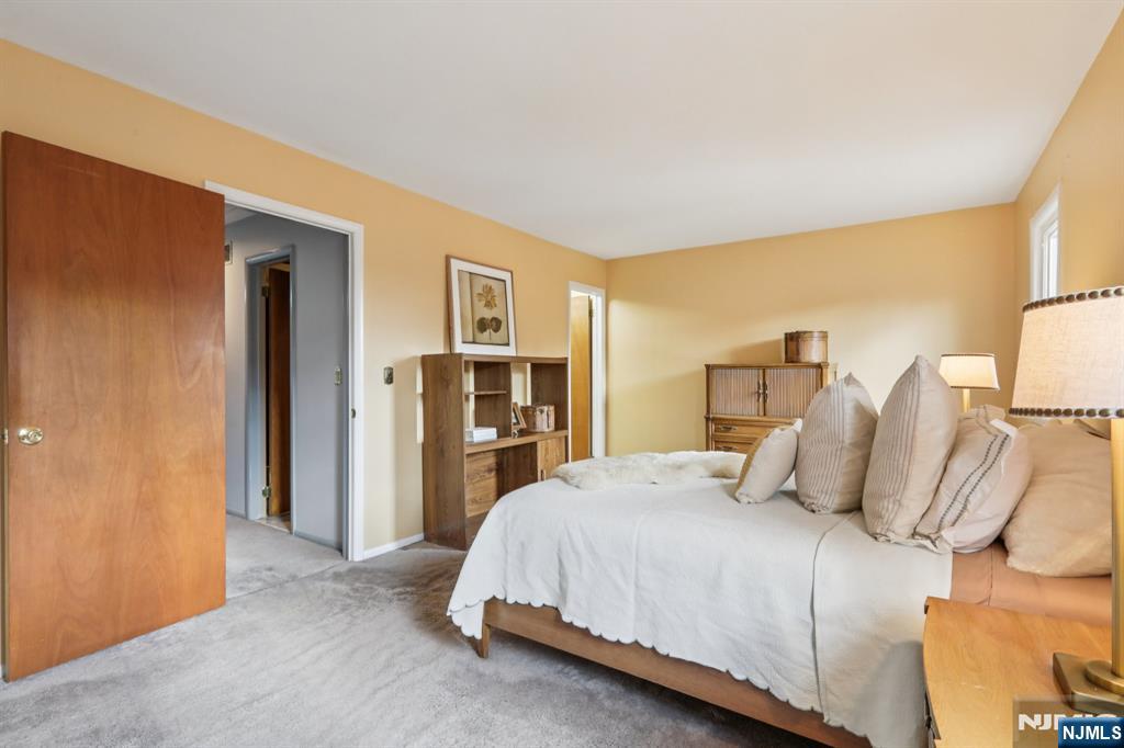 70 River Road, Unit C003 Clifton, NJ 07014 - Photo 26 of 35 a bedroom with a bed and a walk in closet