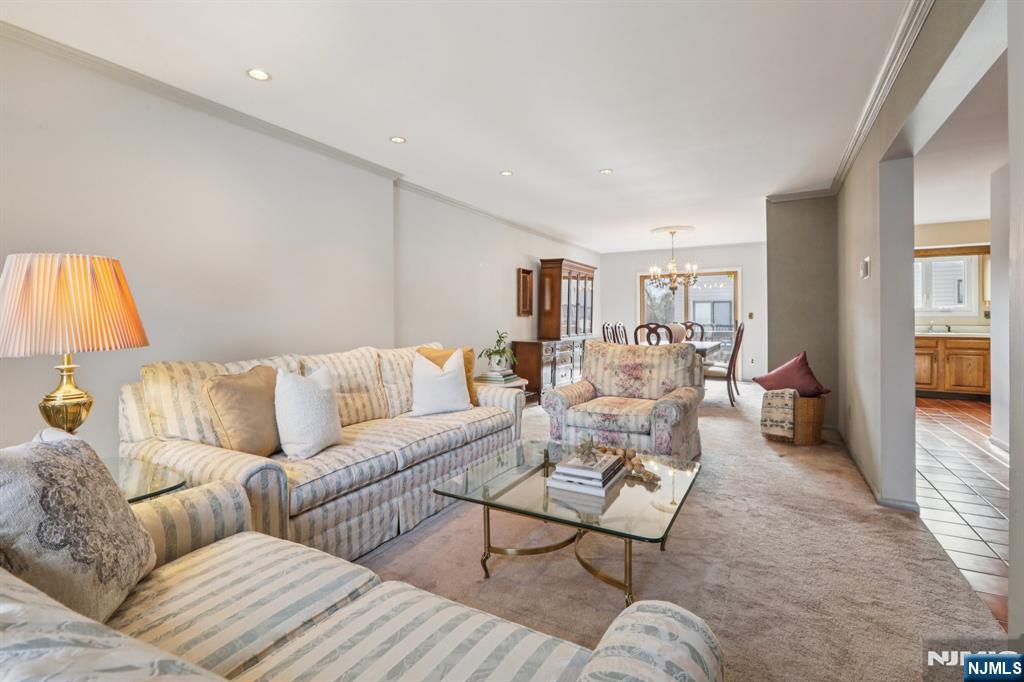70 River Road, Unit C003 Clifton, NJ 07014 - Photo 8 of 35 a living room with furniture and a wooden floor