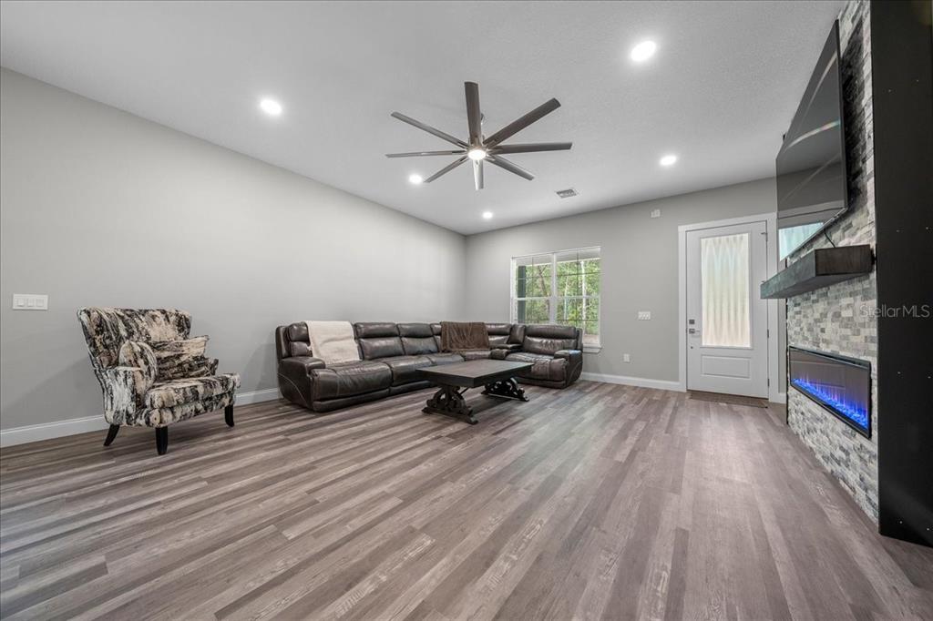 252 Malauka Road Ocklawaha, FL 32179 - Photo 11 of 78 a living room with furniture and a fireplace