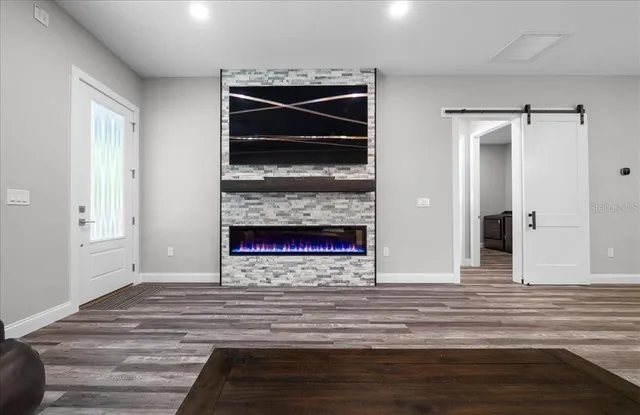 a kitchen with a refrigerator a stove a microwave and wooden cabinets