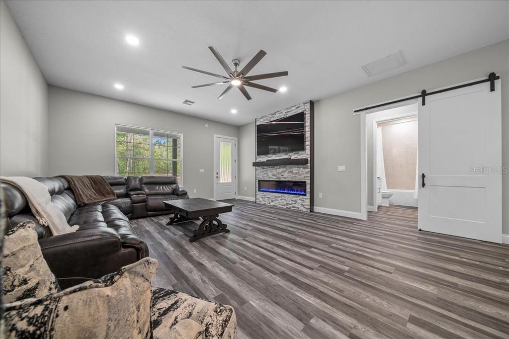 252 Malauka Road Ocklawaha, FL 32179 - Photo 13 of 78 a living room with furniture and a wooden floor