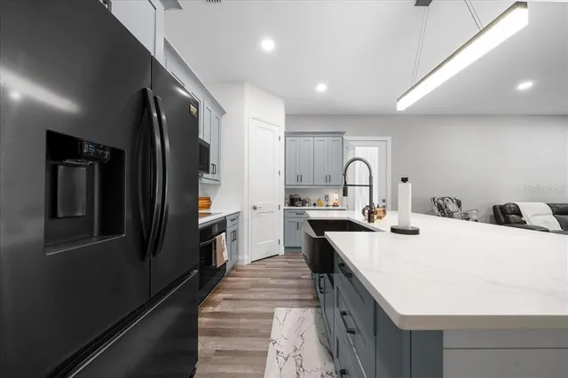 a bathroom with a sink a toilet a mirror and shower