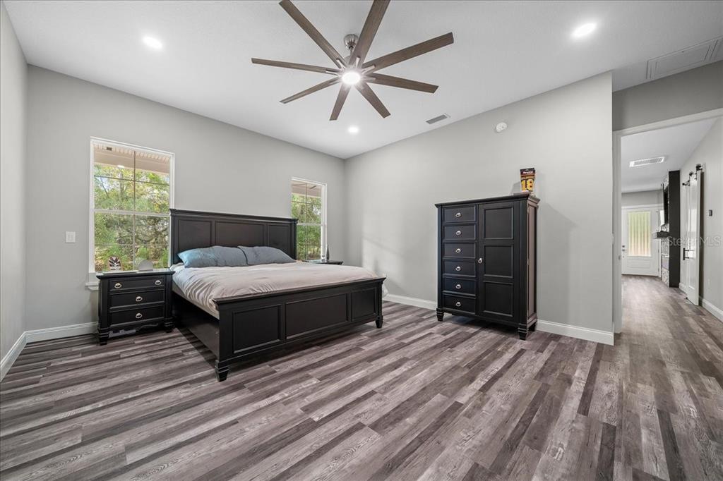 252 Malauka Road Ocklawaha, FL 32179 - Photo 23 of 78 a bedroom with a bed and a ceiling fan